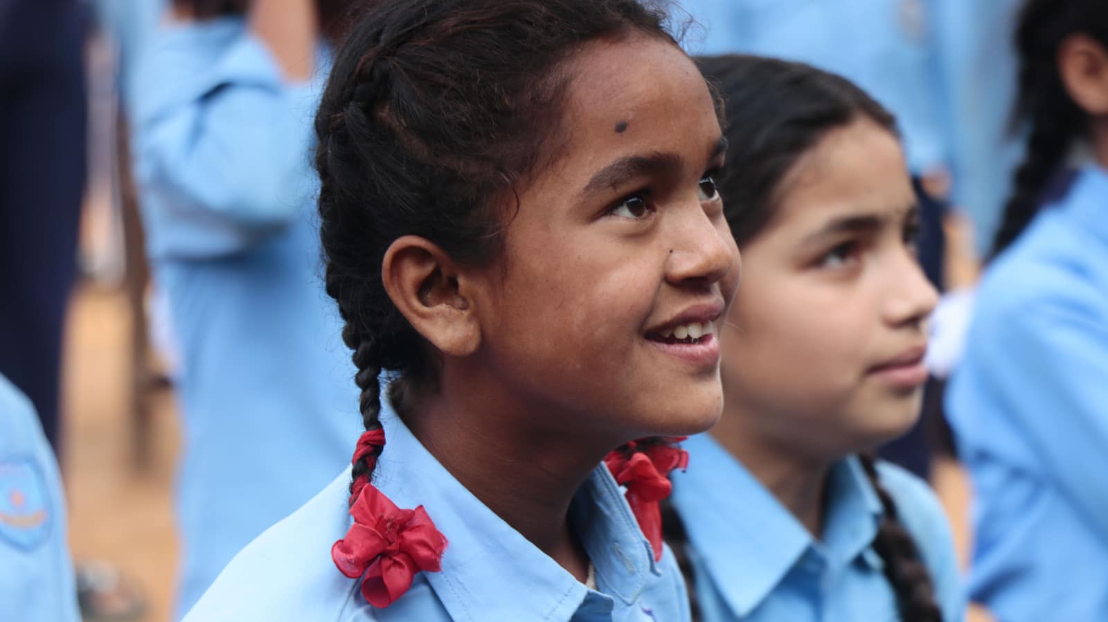 Nepali schoolchildren in uniform at an outdoor school assembly
