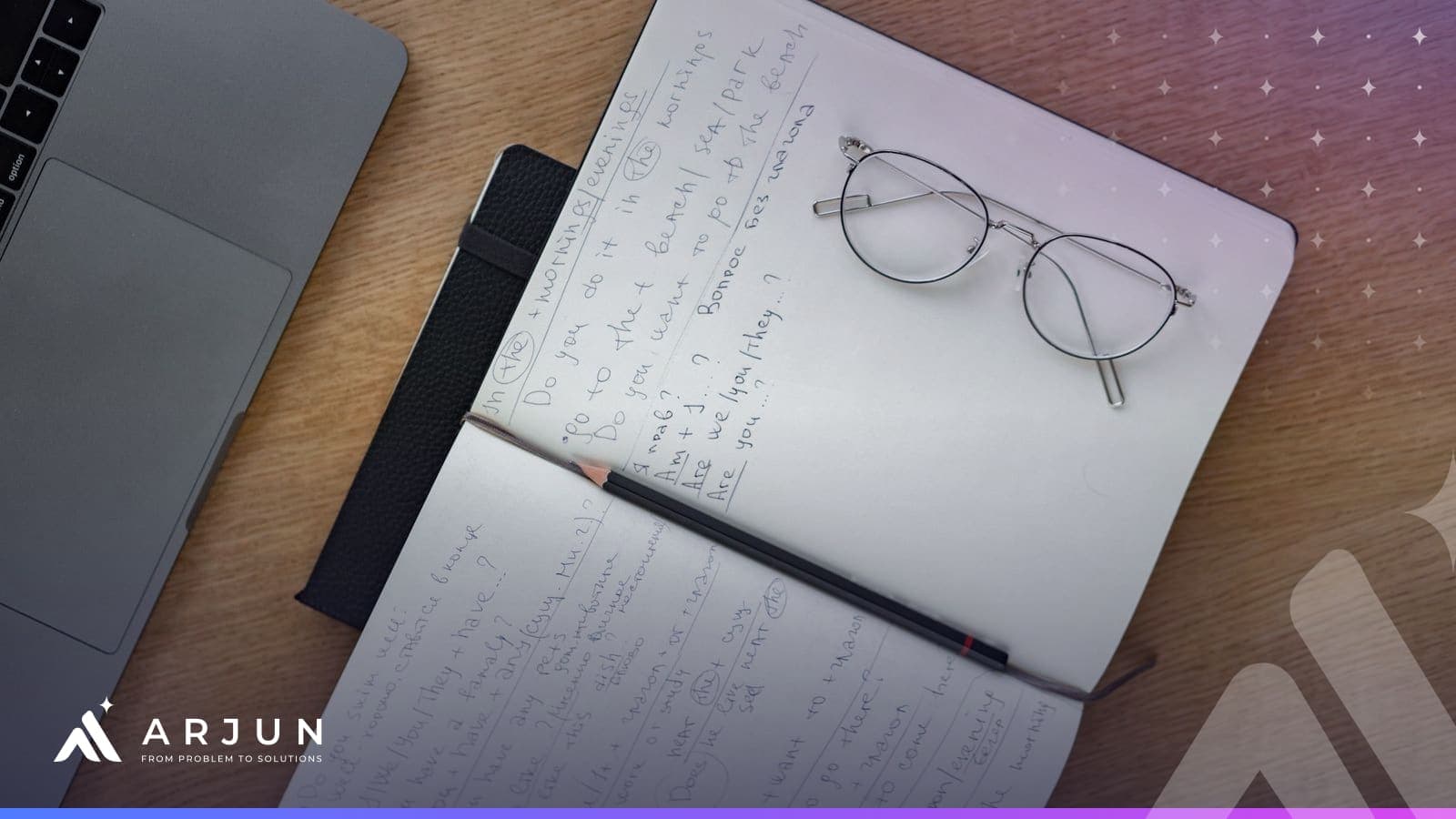 An open notebook of handwritten structured notes with glasses and a pencil beside a laptop